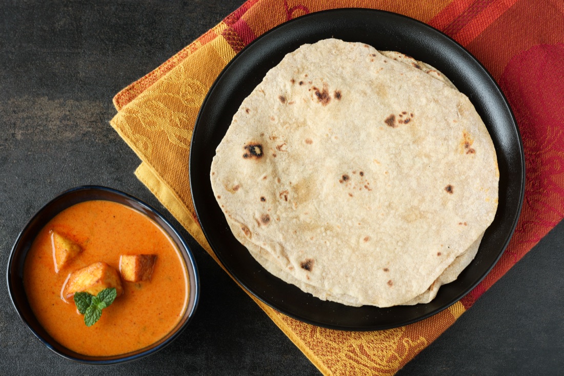 Fresh whole-wheat rotis served with curry
